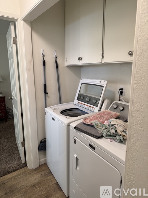A small laundry room with a washer and dryer.