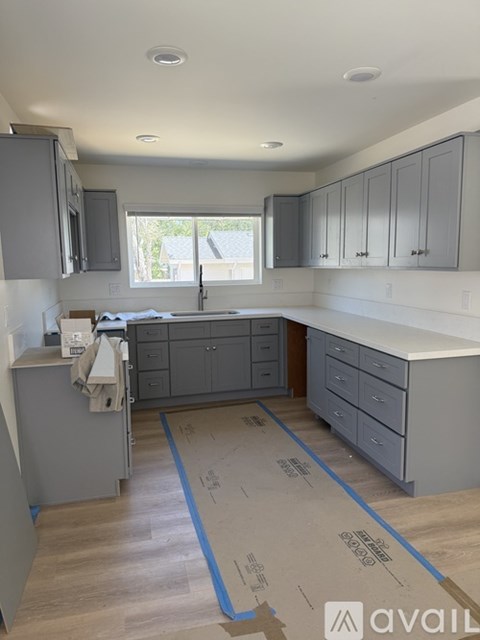 A kitchen under construction with cabinets and a countertop.