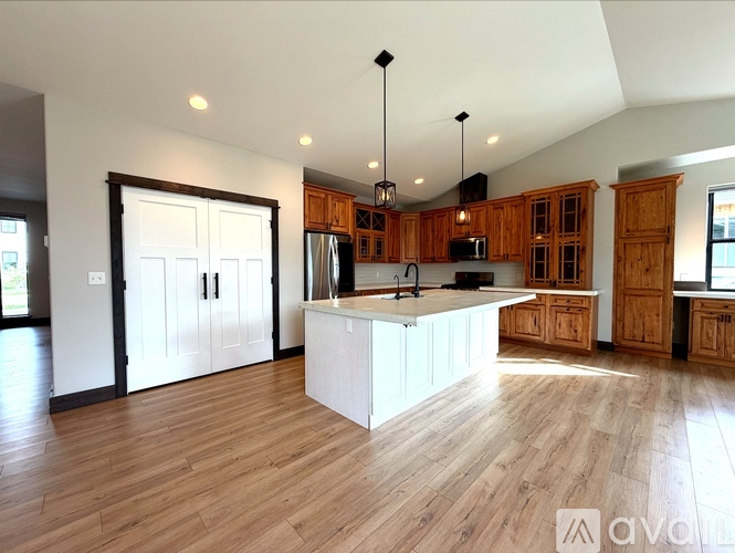 A kitchen with wooden cabinets and a central island.