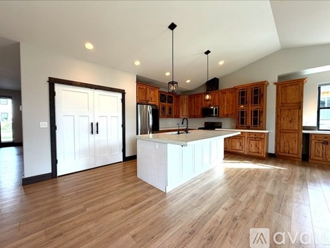 A kitchen with wooden cabinets and a central island.