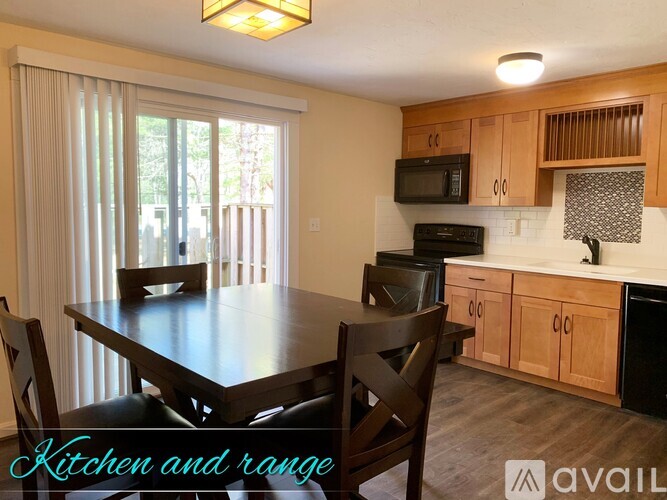 A kitchen and dining area with a table and chairs.