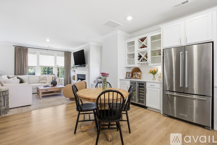 A modern kitchen with a dining table and chairs.