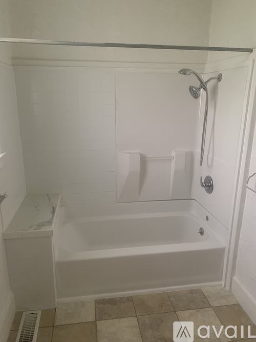 A white bathroom with a tub and shower.