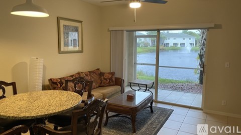 A living room with a dining table and chairs.