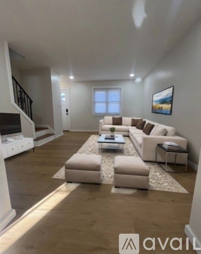 A living room with a white couch and a coffee table.