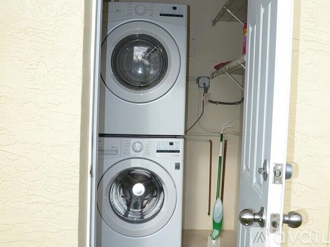 A washing machine is in a small laundry room.