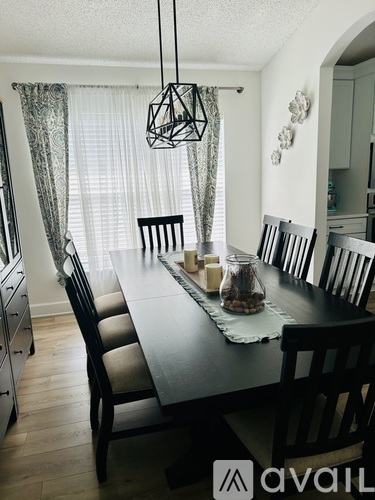 A dining room with a long table and chairs.
