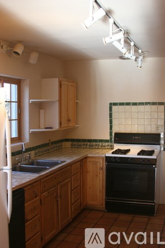 A kitchen with wooden cabinets and a black oven.
