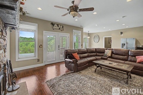 A living room with a brown leather couch and a wooden coffee table.
