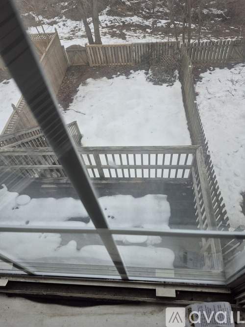 A view from inside a building looking out through a window at a snow-covered landscape.