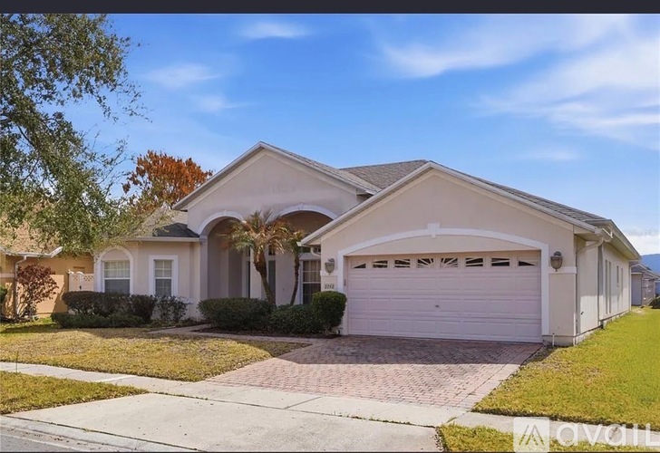 A two-story house with a garage is for sale.