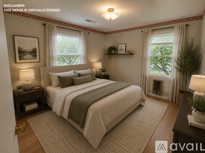 A bedroom with a large bed and a window with curtains.