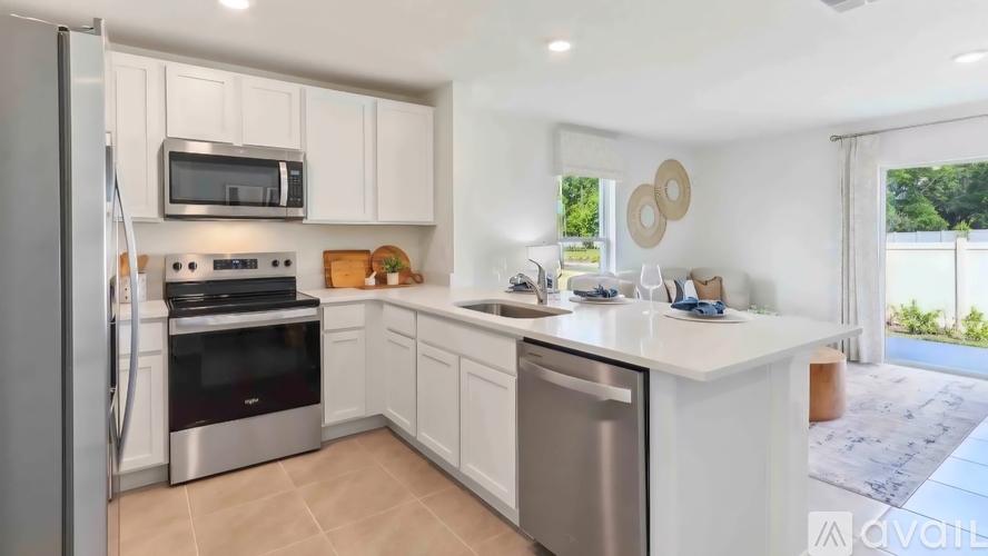 A kitchen with white cabinets and stainless steel appliances.