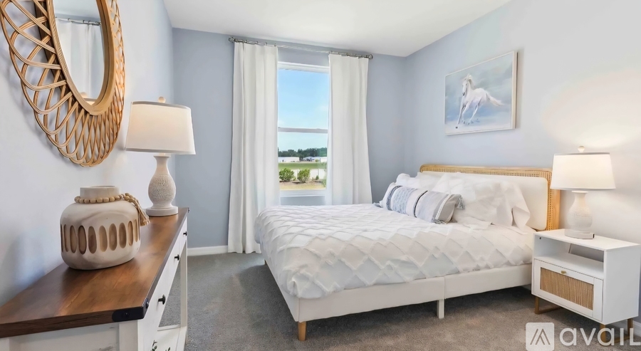 A bedroom with a large bed, a wooden dresser, and a mirror on the wall.