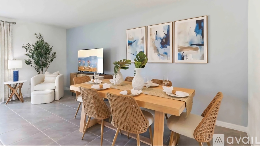 A dining room with a wooden table set for four.
