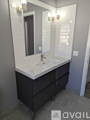 A bathroom with a sink and mirror.