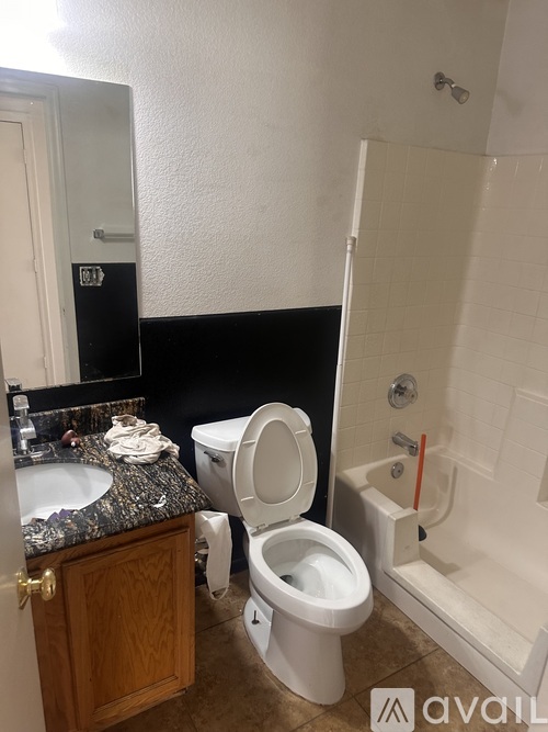 A bathroom with a toilet, sink, and bathtub.