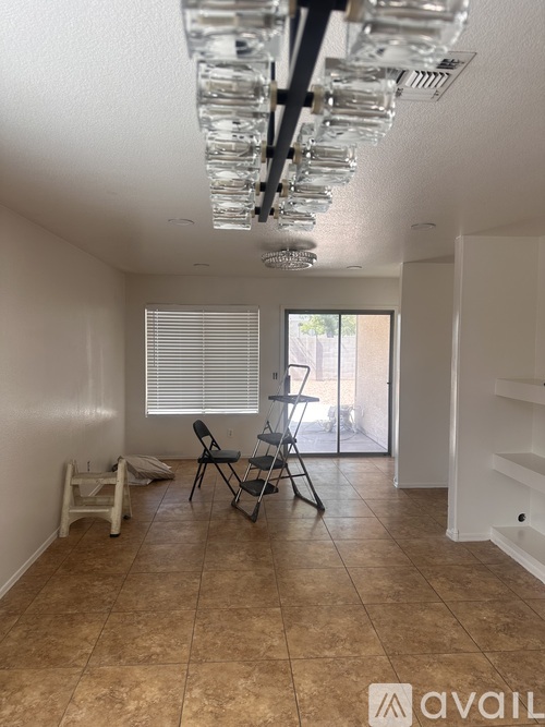 A room with a tiled floor and a glass chandelier.