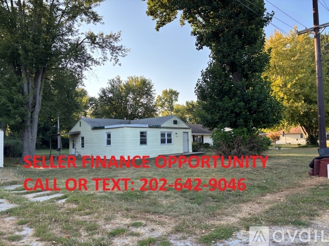 A house with a sign offering seller finance opportunities.