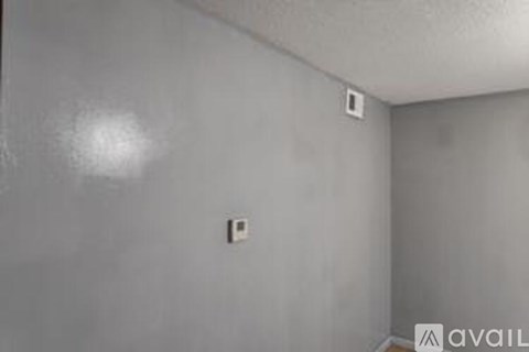 A room with a light switch on the wall.