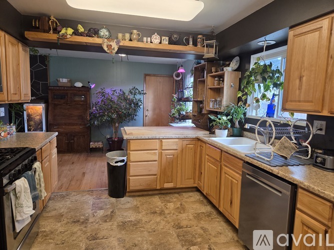 A kitchen with wooden cabinets and a marble countertop.