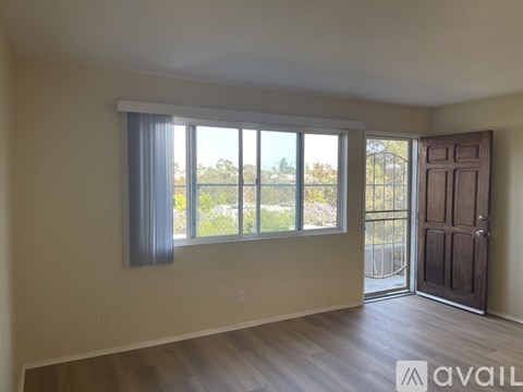A room with a large window and a sliding door.