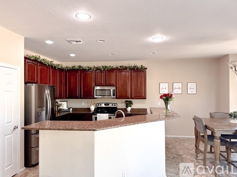 A kitchen with brown cabinets and a white island.