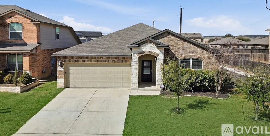 A house with a garage and a driveway is for sale.