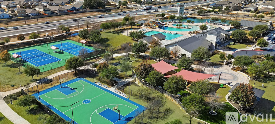 A park with a basketball court and a tennis court.