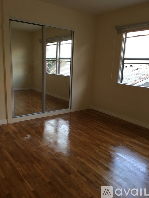 A room with wooden floors and a sliding glass door.