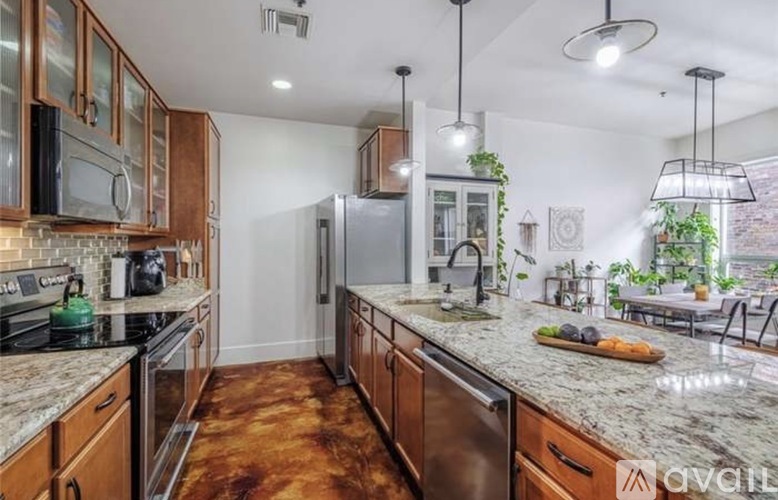 A kitchen with wooden cabinets and granite countertops.
