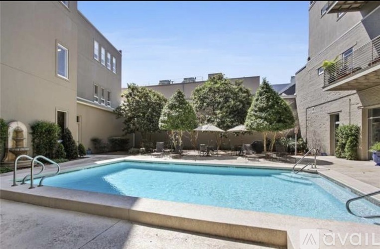 A swimming pool surrounded by buildings and trees.