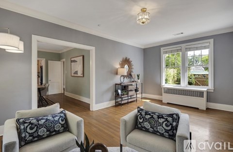 A living room with two couches and a table with a vase on it.