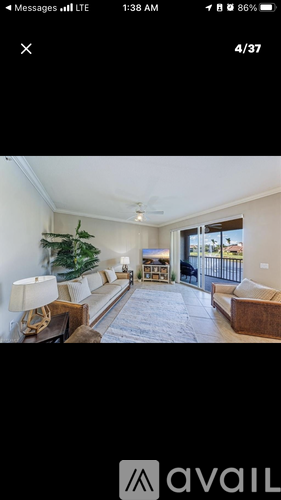 A living room with a Christmas tree and a couch.