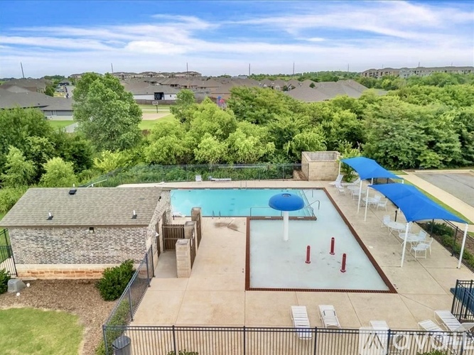 A pool with a blue cover and a diving board.