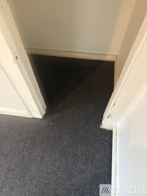 A dark space is visible under a door.