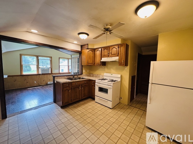 A kitchen with a white refrigerator, white stove, and white oven.