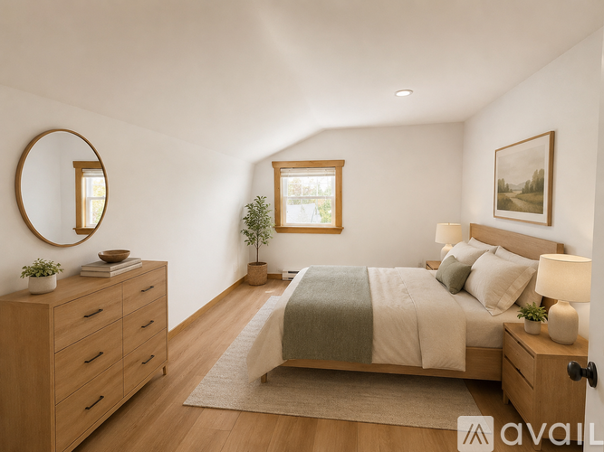 A bedroom with a bed, dresser, and mirror.