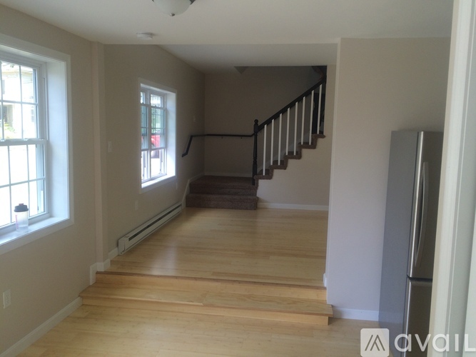 A room with wooden floors and a staircase.