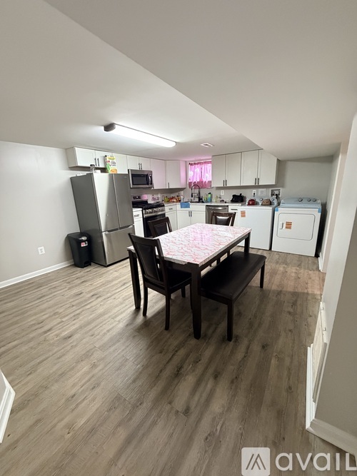 A kitchen with a table and chairs in the middle of the room.