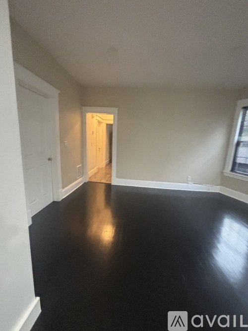 A room with black flooring and white walls.