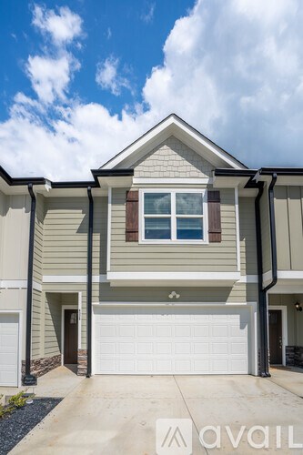 A modern house with a garage door and a window.