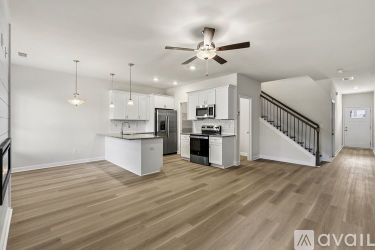 A spacious kitchen with a stove top oven and a refrigerator.