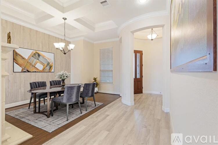 A dining room with a wooden table and chairs.