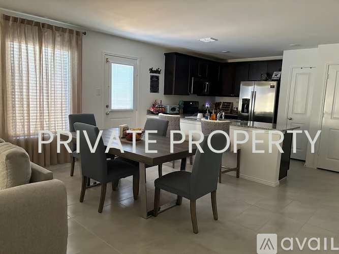 A kitchen with a dining table and chairs is available for rent.