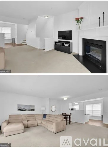A living room with a beige sofa and a fireplace.