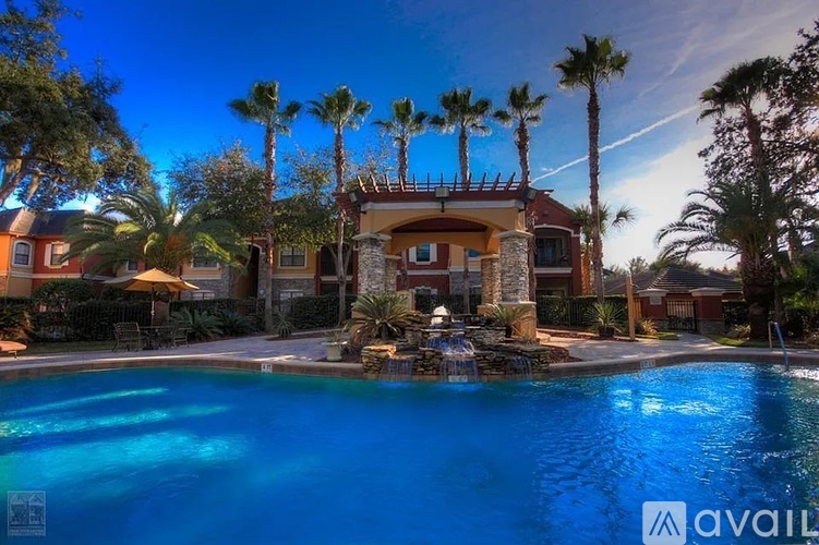 A house with a pool in front of it surrounded by palm trees.
