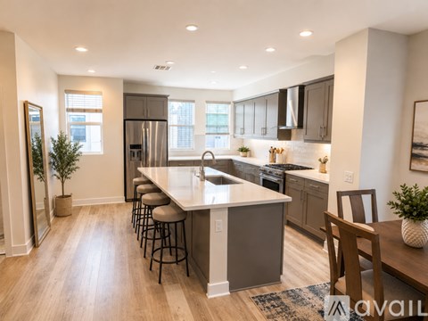 A modern kitchen with a large island and stainless steel appliances.