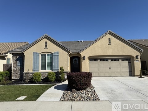 A house with a garage and a driveway in front.