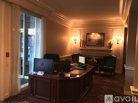 A room with a desk and chairs with Avail sign.